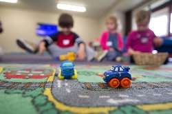 trains on a rug in an ECC center